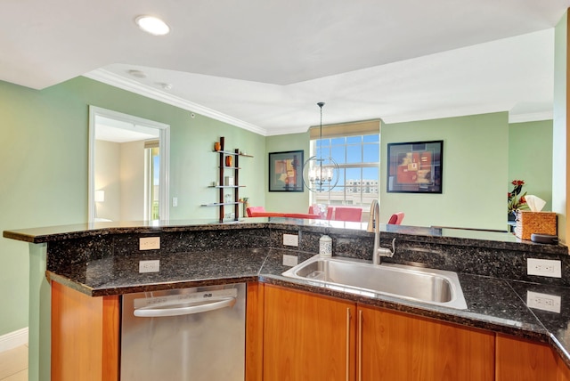 kitchen with hanging light fixtures, sink, stainless steel dishwasher, an inviting chandelier, and dark stone counters