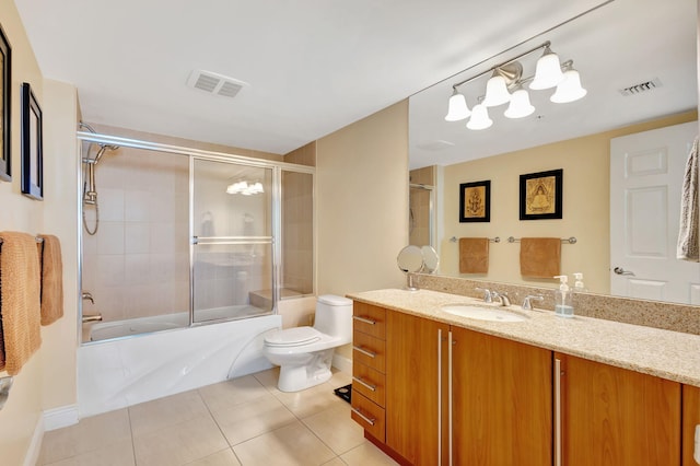 full bathroom featuring tile patterned floors, toilet, vanity, and combined bath / shower with glass door