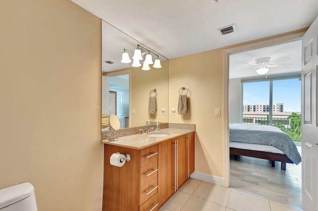 bathroom featuring wood-type flooring, vanity, toilet, and ceiling fan