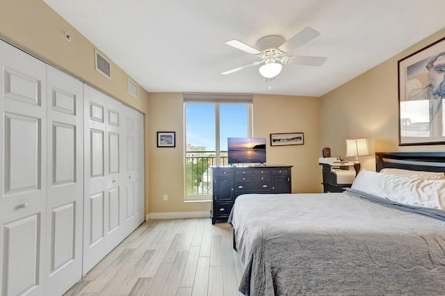 bedroom with a closet, light wood-type flooring, and ceiling fan