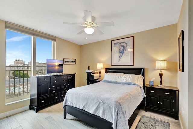 bedroom featuring ceiling fan and light hardwood / wood-style flooring