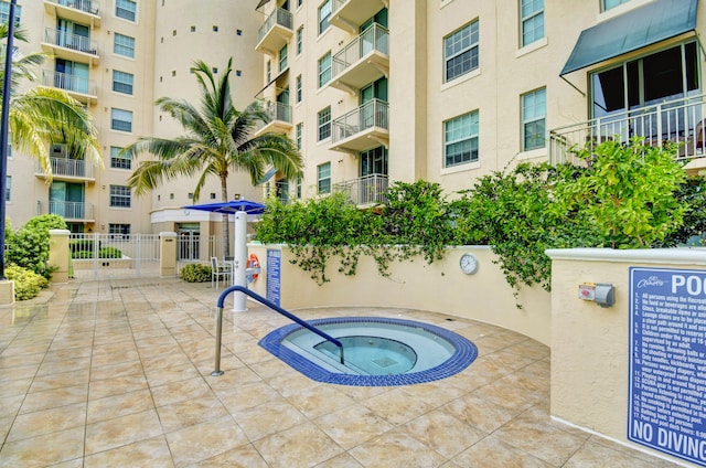 view of swimming pool featuring a hot tub