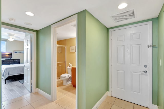 corridor with light tile patterned floors