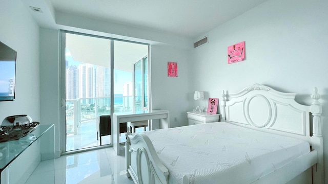 bedroom with multiple windows, access to outside, and light tile patterned floors