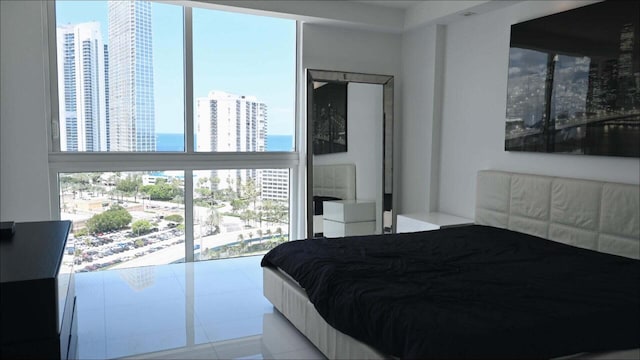 bedroom featuring multiple windows and light tile patterned floors