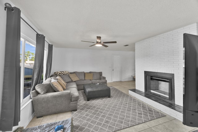 5000 Fort Pierce Blvd, Fort Pierce, FL 34951 - living room featuring light tile patterned floors, a textured ceiling, ceiling fan, and a brick fireplace