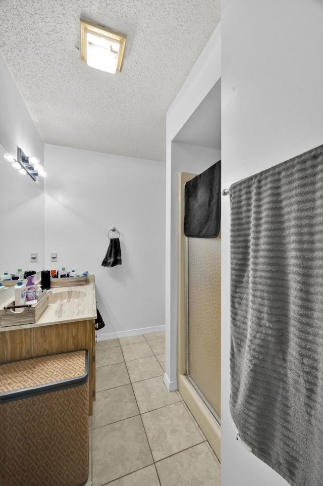 5000 Fort Pierce Blvd, Fort Pierce, FL 34951 - full bath with vanity, a textured ceiling, a shower with door, tile patterned floors, and baseboards
