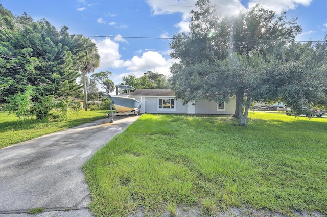 5000 Fort Pierce Blvd, Fort Pierce, FL 34951 - view of front of house featuring concrete driveway and a front lawn