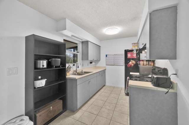 5000 Fort Pierce Blvd, Fort Pierce, FL 34951 - kitchen with a sink, gray cabinetry, light countertops, under cabinet range hood, and a textured ceiling