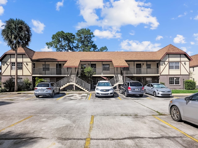 view of property featuring uncovered parking