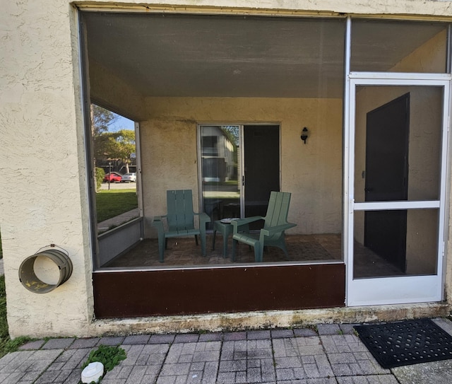 view of patio / terrace featuring a sunroom