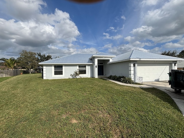 view of front of house with a front yard and a garage