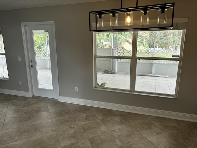 unfurnished dining area with baseboards