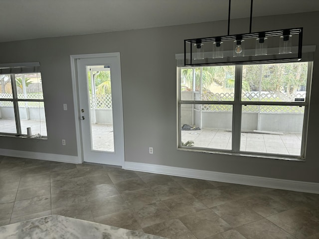 unfurnished dining area with baseboards