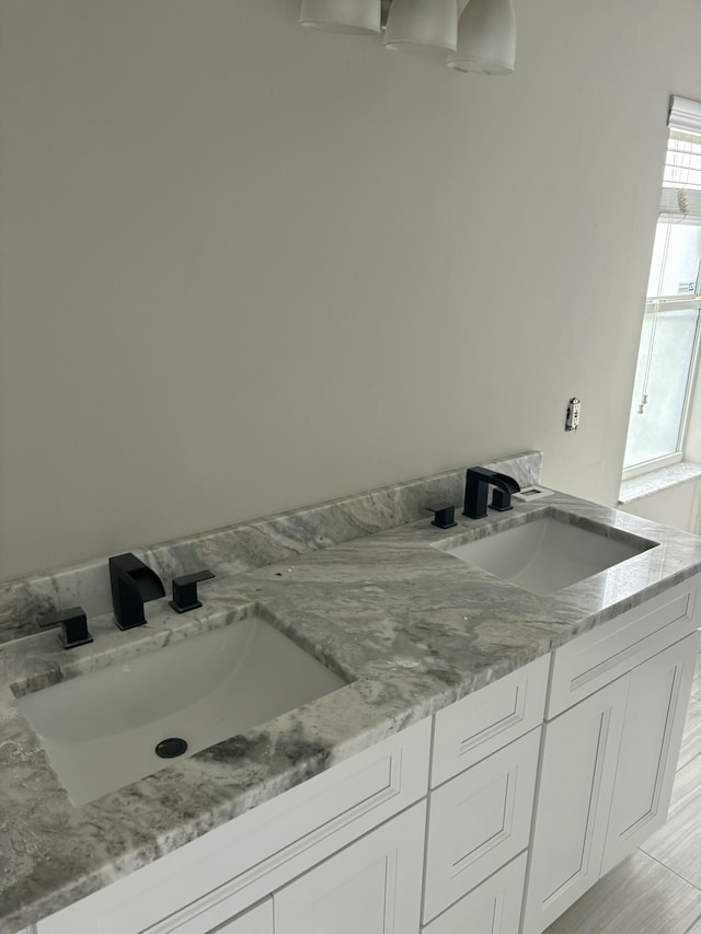 full bath featuring a sink and double vanity