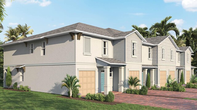 view of front of house featuring a front yard and a garage