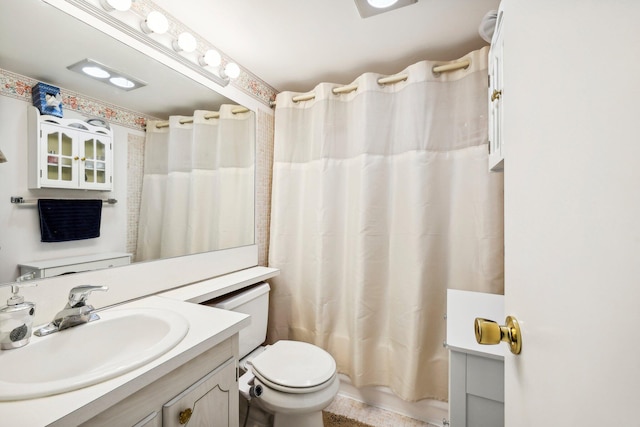 full bathroom featuring shower / tub combo, vanity, and toilet