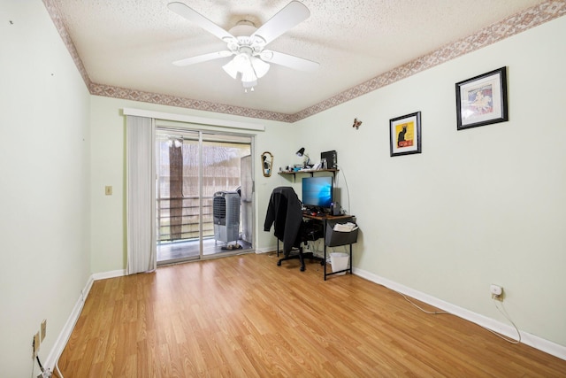 office with a textured ceiling, light hardwood / wood-style floors, and ceiling fan