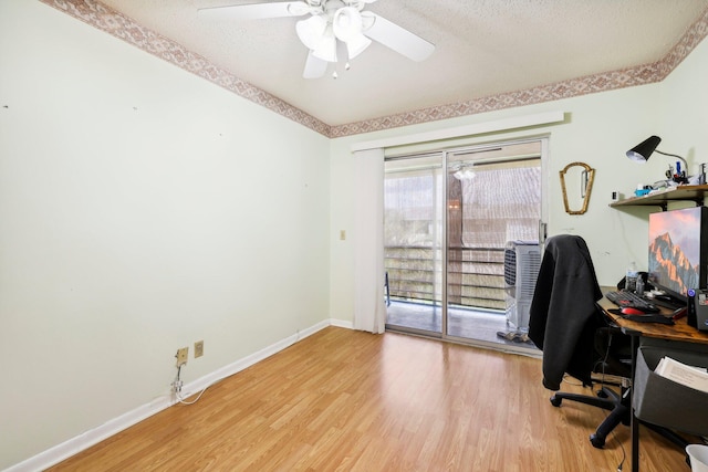 office space featuring ceiling fan, a textured ceiling, and light hardwood / wood-style flooring