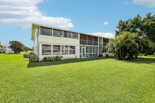 rear view of house featuring a yard