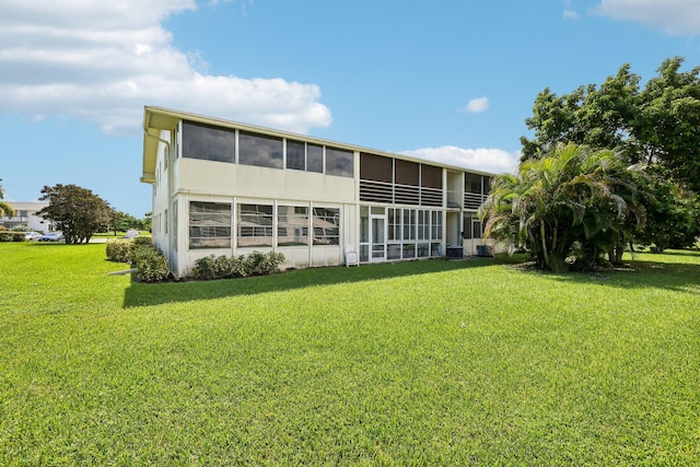 rear view of property with a yard