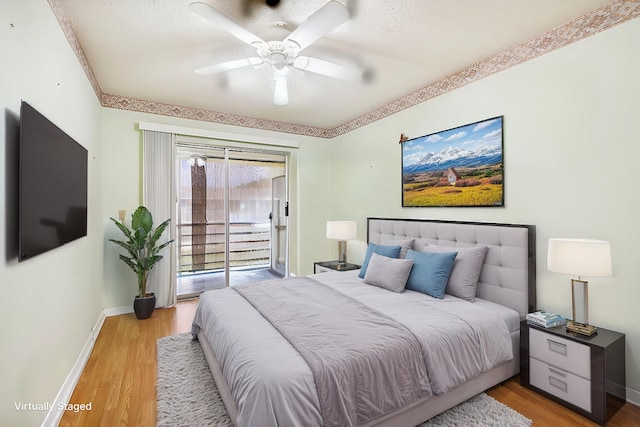 bedroom featuring hardwood / wood-style flooring, access to outside, and ceiling fan