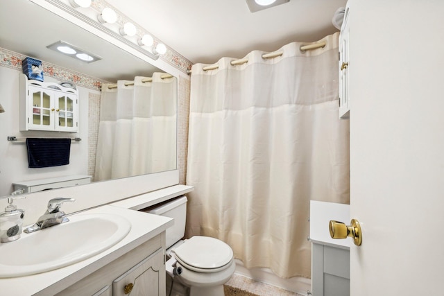 full bathroom with vanity, shower / tub combo with curtain, and toilet