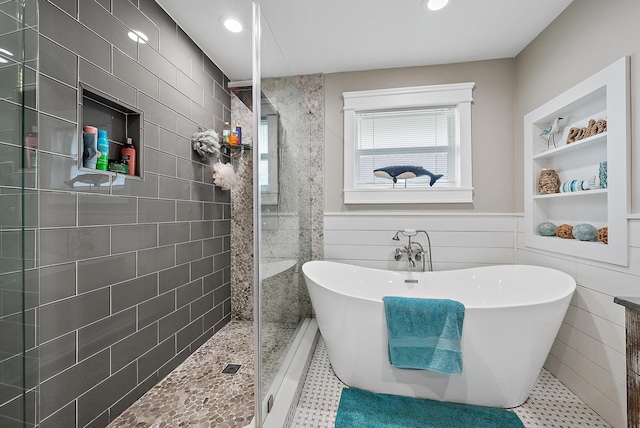 bathroom with built in shelves, tile patterned flooring, and independent shower and bath