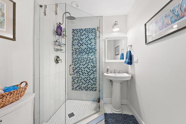 bathroom featuring toilet, tile patterned flooring, and a shower with door