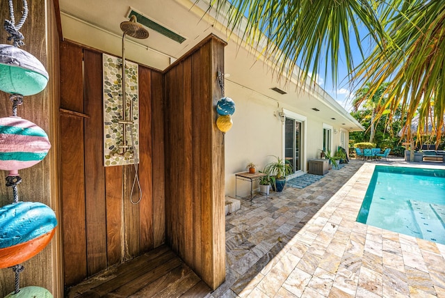 view of swimming pool featuring a patio area