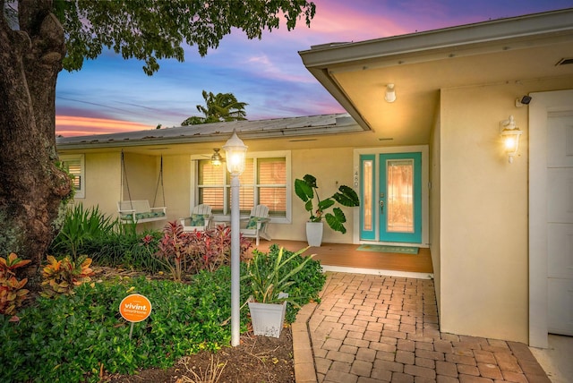 exterior entry at dusk featuring a porch