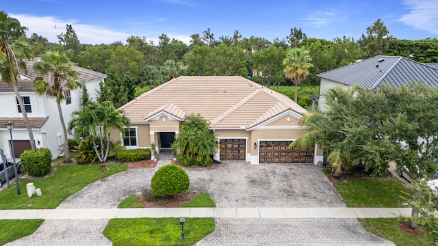 view of front of home with a garage and a front lawn