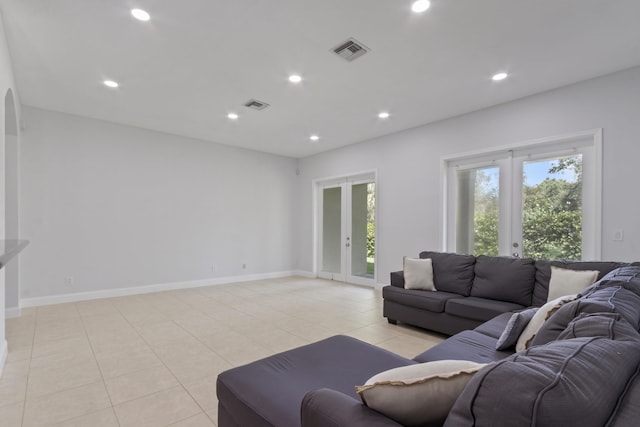 tiled living room featuring french doors