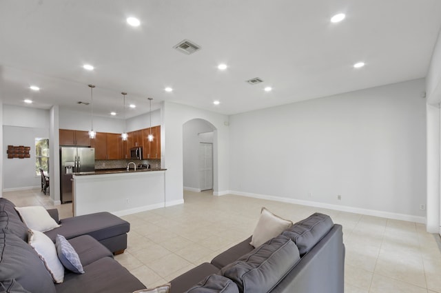 tiled living room featuring sink