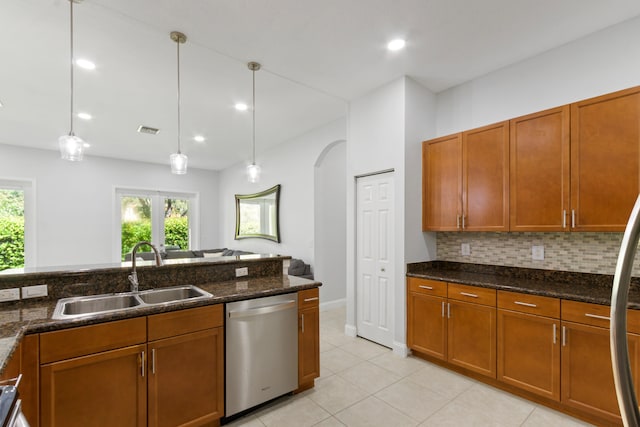 kitchen featuring backsplash, dishwasher, hanging light fixtures, and sink