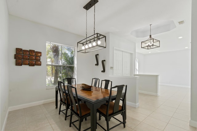 tiled dining area with a chandelier