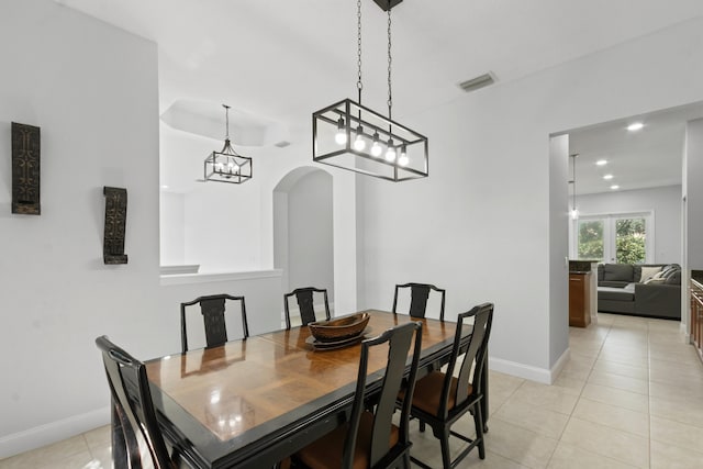 tiled dining space with a notable chandelier