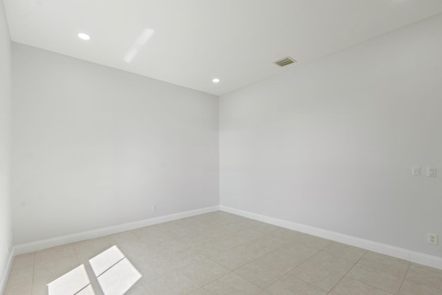 empty room with light tile patterned flooring