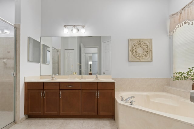 bathroom with vanity, shower with separate bathtub, and tile patterned flooring