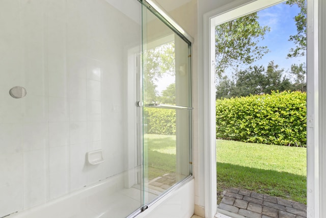 bathroom featuring bath / shower combo with glass door