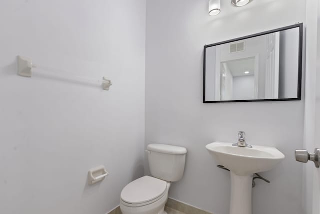 bathroom with toilet and tile patterned floors