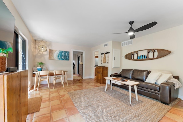 tiled living room with ceiling fan