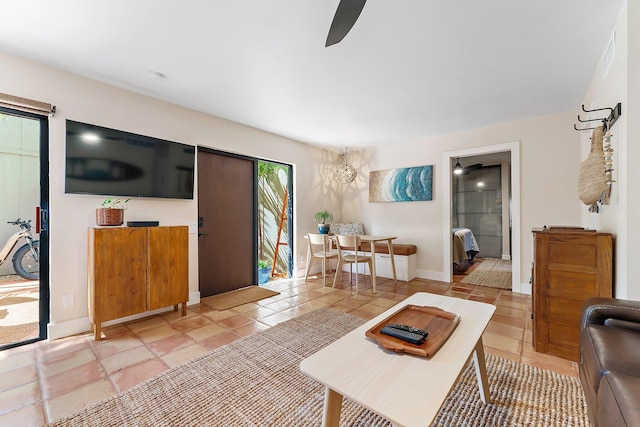 living room featuring ceiling fan and light tile patterned flooring