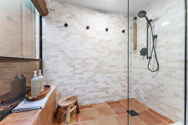 bathroom with tile patterned floors and tiled shower