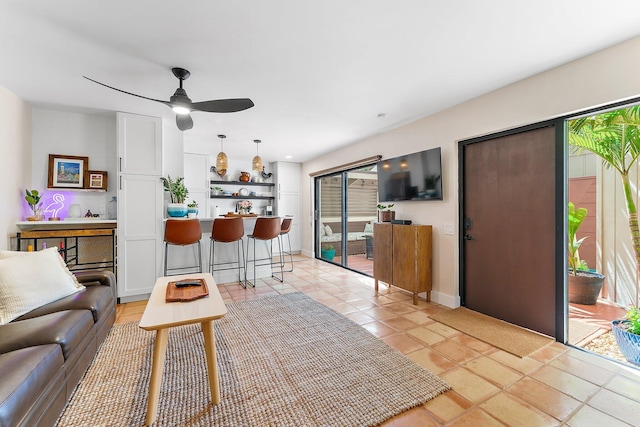 living room with ceiling fan and light tile patterned flooring