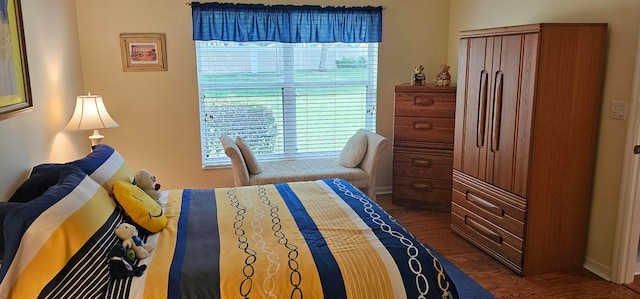 bedroom with dark hardwood / wood-style floors