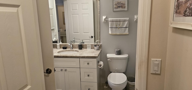 bathroom with toilet and vanity