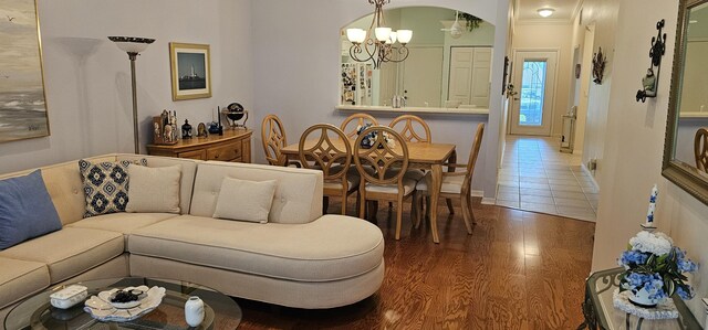 living area with wood finished floors and a notable chandelier