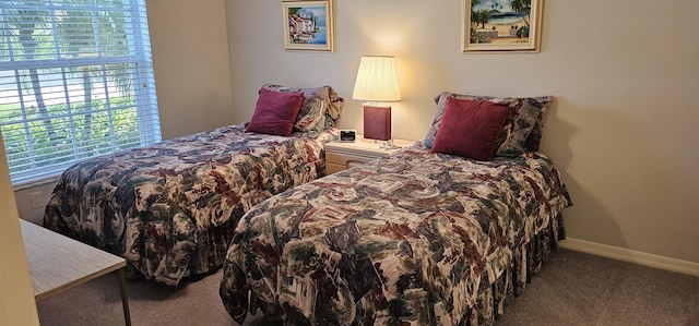 carpeted bedroom featuring baseboards