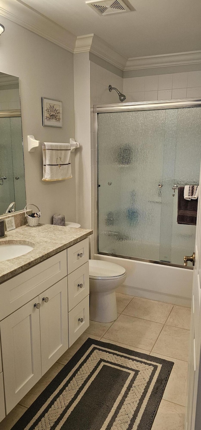 full bathroom with toilet, visible vents, bath / shower combo with glass door, vanity, and ornamental molding